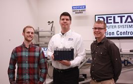 From left to right, David McNichol, Aaron Heinrich and Paul Huumala. Heinrich holds Delta’s new RMC200 motion controller product.
