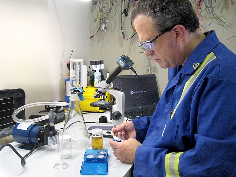 Carl Dyke tests oil samples for particulate contamination.