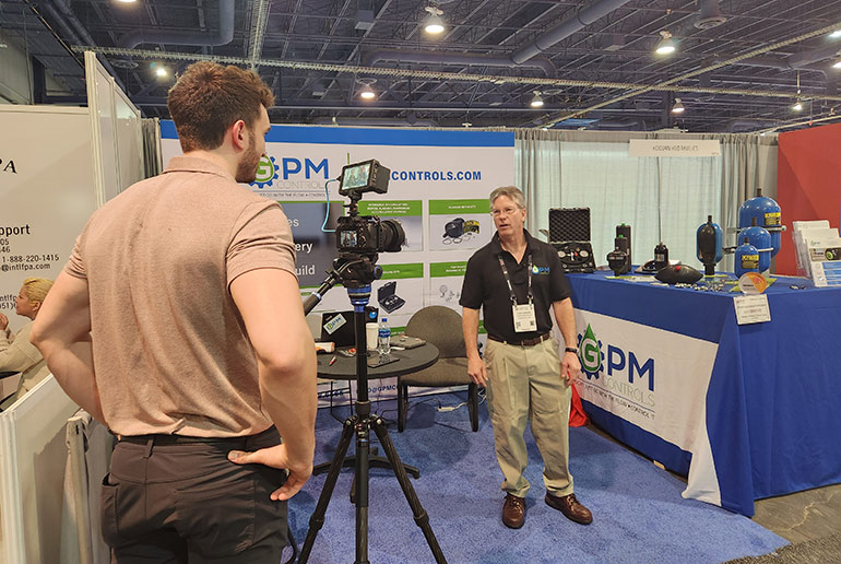 Garrett McCafferty, videographer for FPW, works with Dan Turner, GPM Controls, on an educational video on accumulator technologies.
