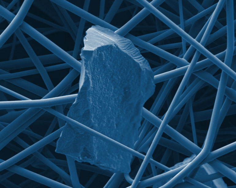Particulate captured in Alpha-Web fine fibers