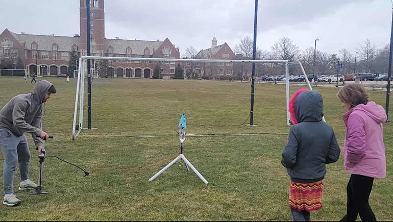 My fifth grader and her friend preparing to launch their bottle rocket at the Science Olympiad.