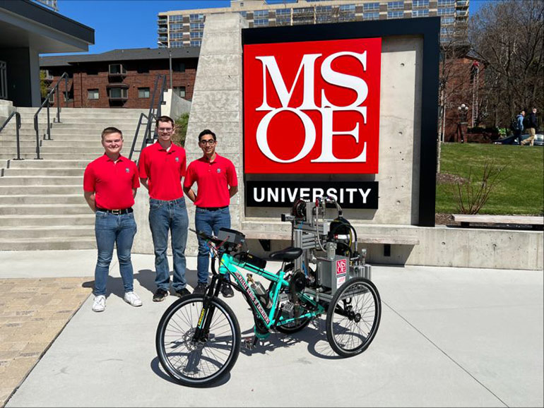 Jeffrey Kaas, Brandon Janes and Daniel Cantu with their hydraulically powered bike built for the NFPA Fluid Power Vehicle Challenge.