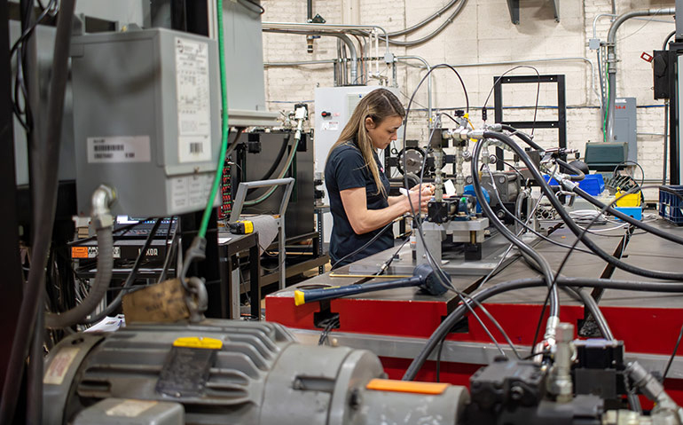 Kathryn Baisley, Test Engineer for the Fluid Power Institute at Milwaukee School of Engineering, works on a test rig for Hallite seals.