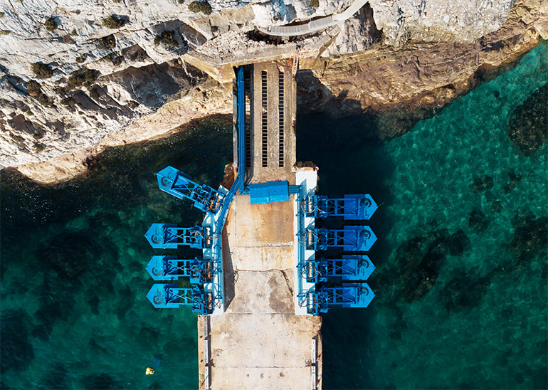 Buoyant floaters convert incoming wave action into hydraulic cylinder motion, which produces high-pressure fluid that powers a hydraulic motor and generator. Courtesy of Eco Wave Power