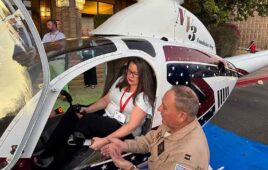 Captain Stewart McQuillan shows Mary Gannon the inner workings of one of many helicopters he's built over the years.