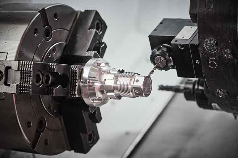 Figure 3. This drilling operation on a CNC lathe machine uses a hydraulic chuck for precision machining of tubes, bars or rods.
