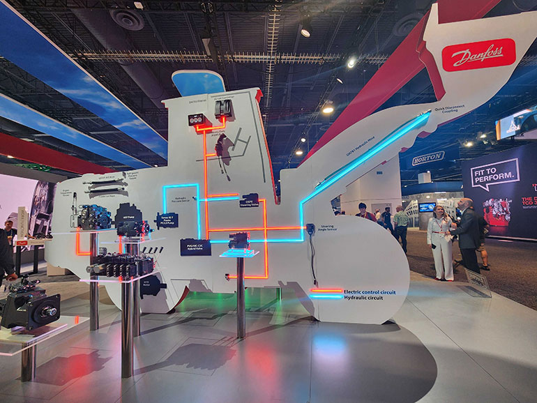 Danfoss' CONEXPO booth was hard to miss with the giant cutout board, highlighting its hydraulics technologies on side, and electronics on the other (below), and how they work together in a complete system.