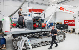 Danfoss Scotland personnel work on converting the Develon DX300LC‑7 crawler excavator to the Danfoss’ Dextreme Max system.